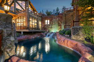 View of pool with a small pond