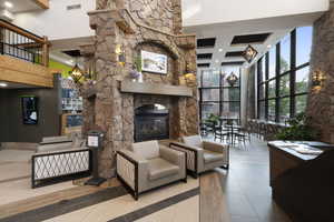 Common area featuring a towering ceiling, recessed lighting, and beam ceiling