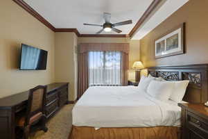 Bedroom featuring ornamental molding, carpet, and ceiling fan