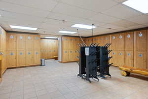 Exercise area featuring a paneled ceiling and wooden walls