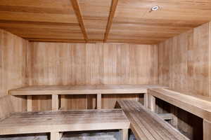 Sauna / steam room featuring wood ceiling and wooden walls