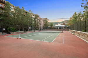 View of tennis court with community basketball court