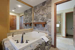 Full bathroom with a whirlpool tub and tile patterned flooring