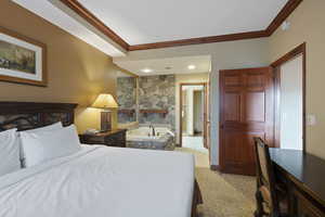 Bedroom featuring crown molding, light colored carpet, and baseboards