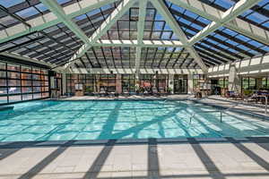 Indoor community pool featuring a patio area