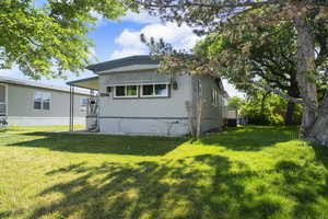 View of front of property with a front lawn and cooling unit
