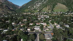 Aerial view of property and surrounding area with a mountain backdrop