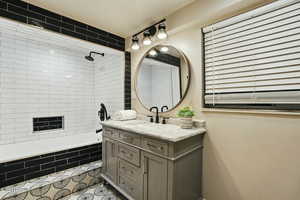 Full bath with vanity, tiled shower / bath, and tile patterned flooring