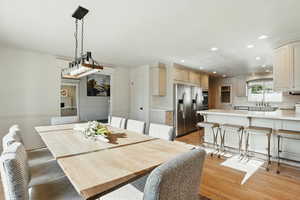 Dining area with recessed lighting and light wood finished floors