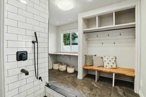 Mudroom with baseboards and a textured ceiling