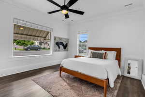 Bedroom featuring baseboards, wood finished floors, and a ceiling fan