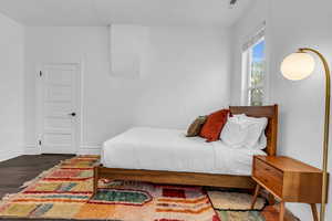 Bedroom with wood finished floors and baseboards