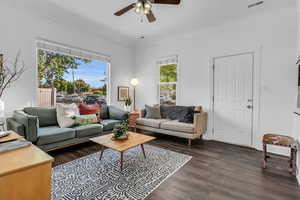 Living room with a ceiling fan and wood finished floors