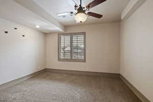Unfurnished room with carpet floors, a ceiling fan, and baseboards