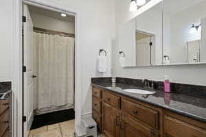 Bathroom featuring vanity and stone finish flooring