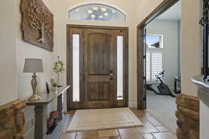Entryway featuring stone tile flooring and baseboards