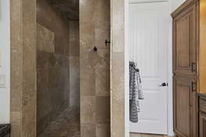 Full bath featuring a tile shower