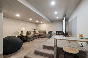 Living area with carpet and recessed lighting