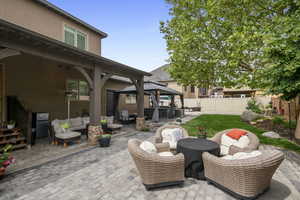 View of patio with a gazebo and an outdoor hangout area