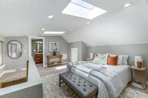 Bedroom with a skylight, light carpet, lofted ceiling, recessed lighting, and baseboards