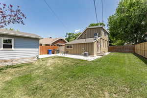 Back of house featuring a patio, central AC, and roof with shingles