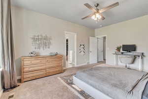 Bedroom with carpet flooring, baseboards, and a ceiling fan