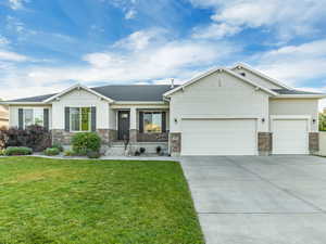 Craftsman house with a garage, stone siding, and concrete driveway