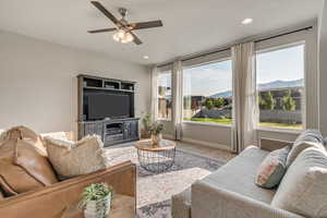 Living area with ceiling fan, recessed lighting, and baseboards