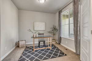 Carpeted office with baseboards