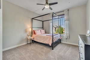 Bedroom featuring baseboards, carpet floors, and a ceiling fan