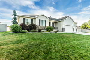 Single story home with a garage, stone siding, and concrete driveway