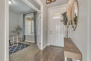 Entryway with baseboards and wood finished floors