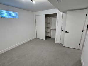 Unfurnished bedroom with carpet floors, baseboards, and a closet