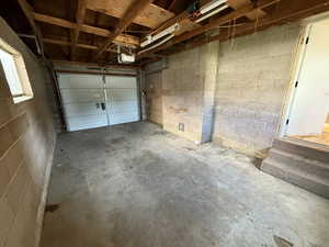 Garage with a garage door opener and concrete block wall