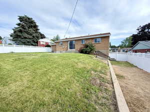 Back of house with entry steps and brick siding