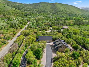 View from above of property with a forest and a mountain backdrop