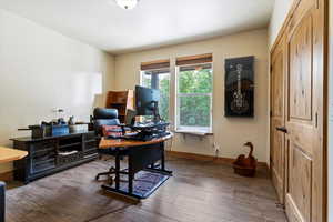 Home office featuring wood finished floors and baseboards