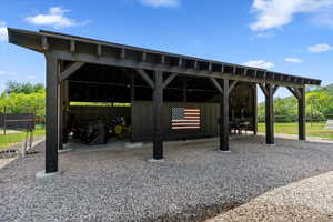View of vehicle parking featuring a carport