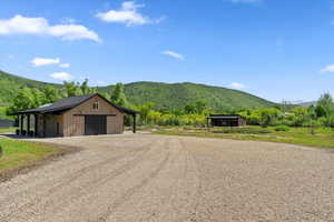 View of street with a mountain view and an outbuilding