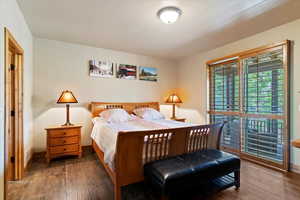 Bedroom with wood finished floors and baseboards
