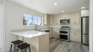 Kitchen with stainless steel appliances and quartz countertops
