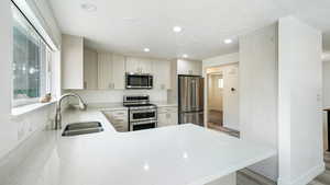 Kitchen featuring appliances with stainless steel finishes and quartz