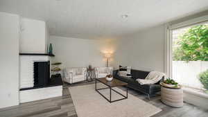 Living room featuring plenty of natural light and brick fireplace