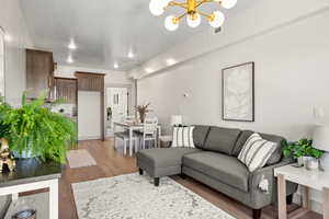 Living room with a chandelier and light wood-type flooring