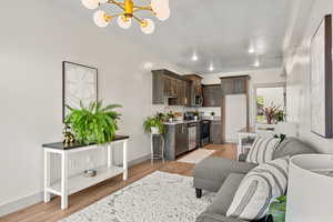 Living area featuring a chandelier and light wood-style floors