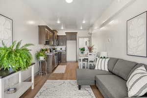 Living room featuring light wood-style flooring and baseboards