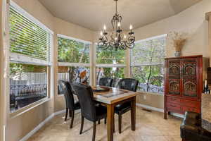 Dining area featuring healthy amount of natural light, baseboards, and light tile patterned floors