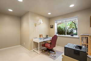 Carpeted office space featuring recessed lighting and baseboards
