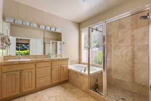 Bathroom with a stall shower, healthy amount of natural light, and tile patterned floors