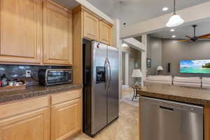 Kitchen with appliances with stainless steel finishes, light brown cabinetry, tile counters, a ceiling fan, and recessed lighting
